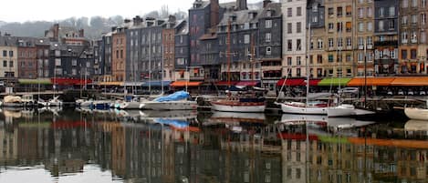 A waterfront with historic buildings and boats docked.