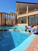 Outdoor pool, open 9:00 AM to 8:00 PM, pool umbrellas, pool loungers