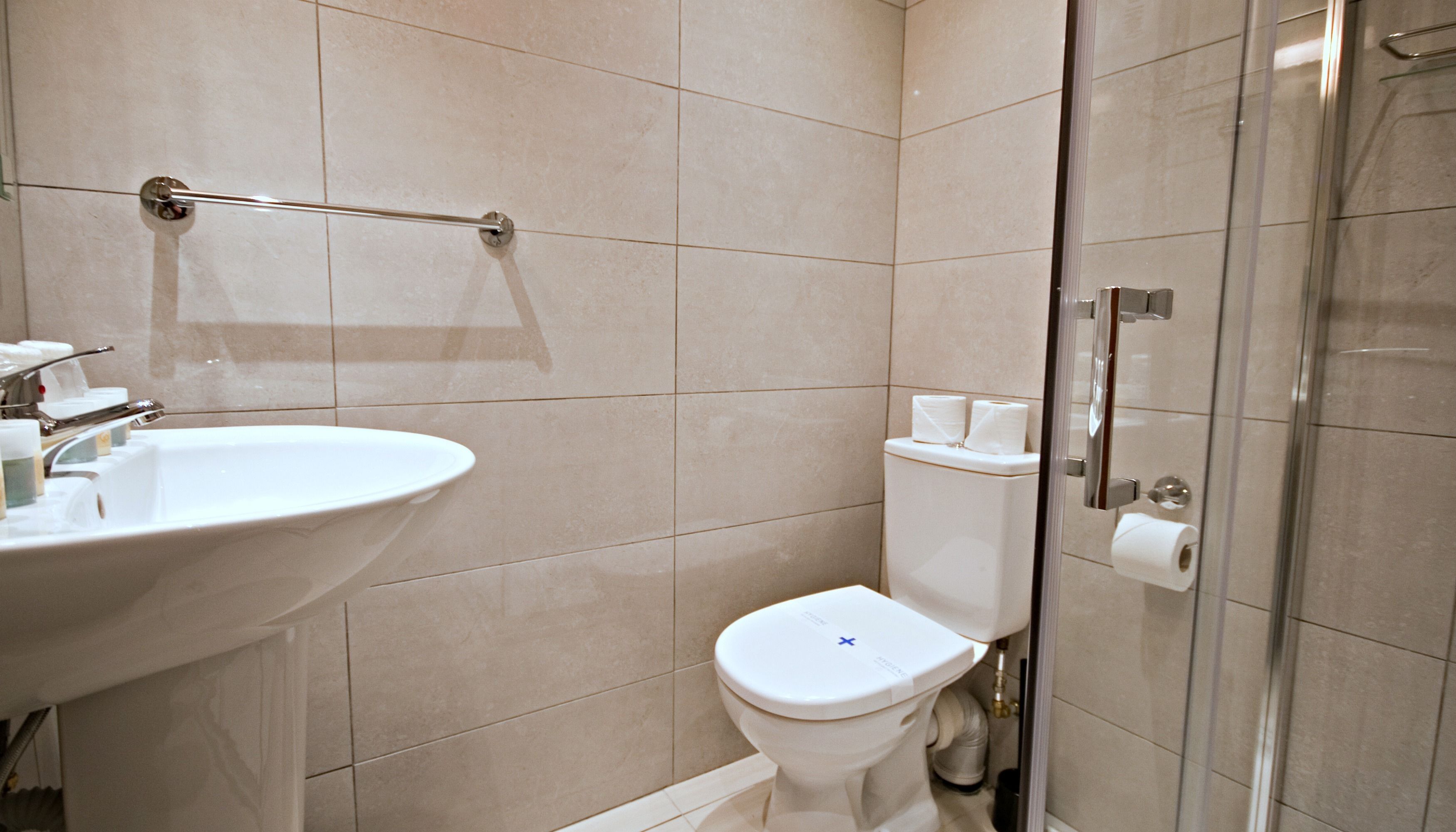 A bathroom with a sink, toilet, and shower.