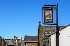 A pub sign with a dog and a crown, indicating a themed establishment. - The Crown Hotel (Lynton)
