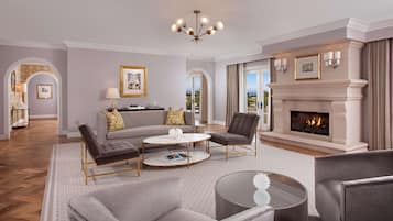 A spacious living room with a fireplace, comfortable seating, and a view of the outdoors.