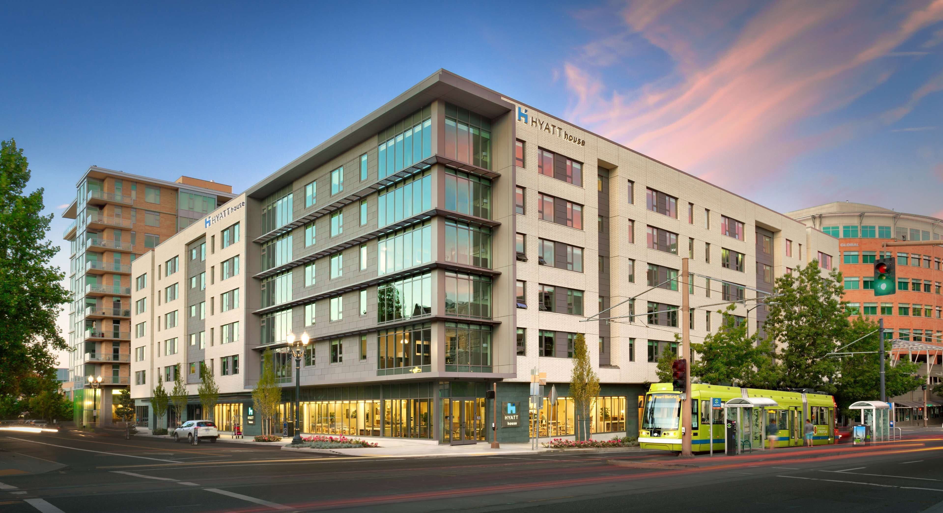 A multi-story hotel with a modern design, featuring large windows and a prominent entrance.
