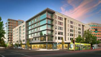 A multi-story hotel with a modern design, featuring large windows and a prominent entrance.