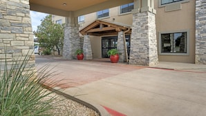 A building with a stone facade, a covered entrance, and large windows. - Best Western Plus Big Lake Inn (Big Lake)