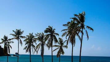 On the beach, white sand, sun-loungers, beach towels