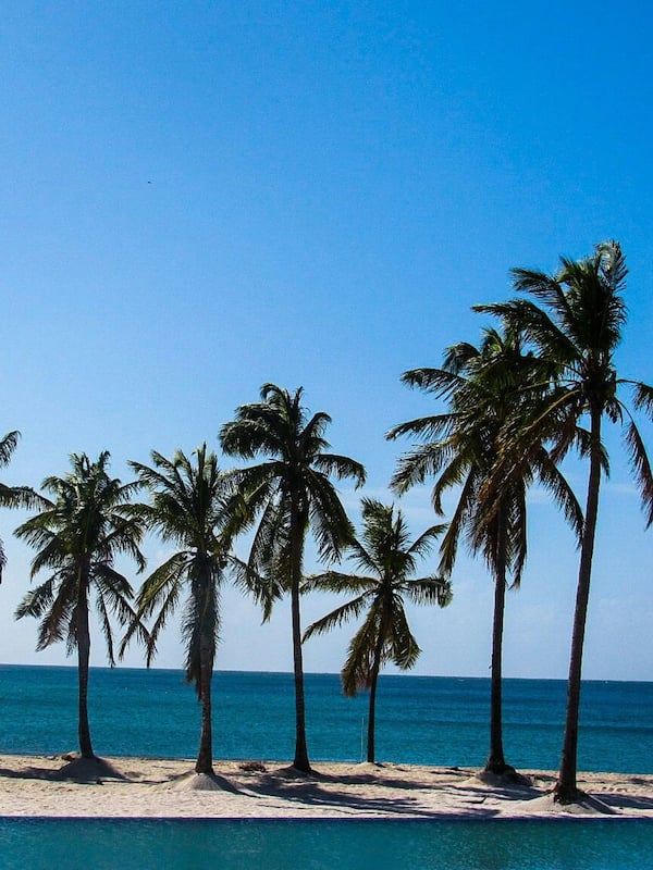 On the beach, white sand, sun loungers, beach towels