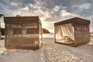 On the beach, white sand, sun loungers, beach towels