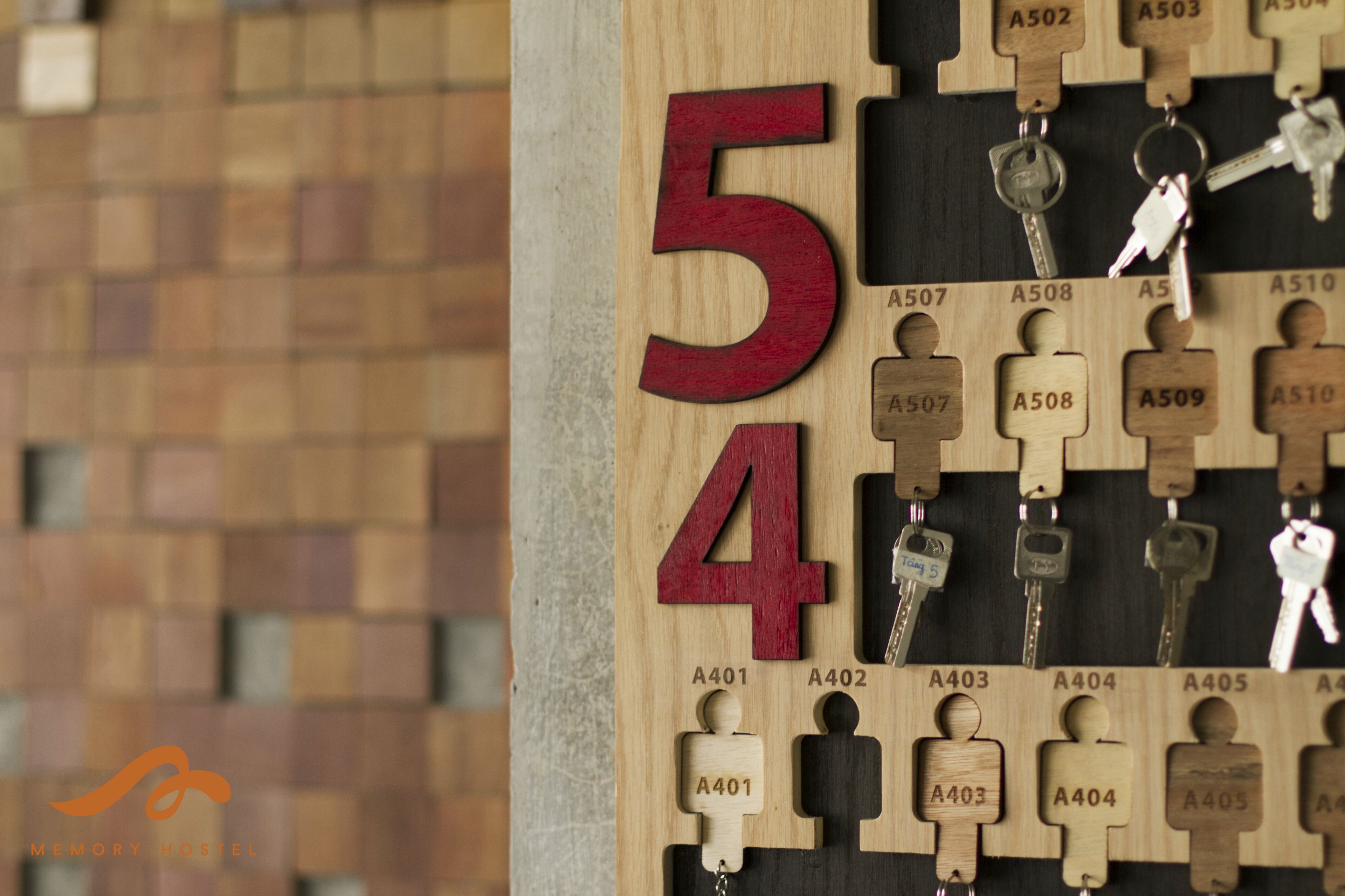 A wooden keychain wall with numbered keys and a large '54' sign.