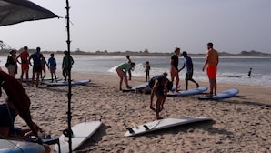 A beach with people preparing surfboards. - The Bavarian Resort (Arugam Bay)
