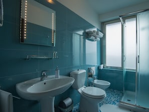 Deluxe Quadruple Room | Bathroom | Shower, hair dryer, slippers, bidet