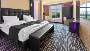 A modern hotel room with a large bed, a desk, and a TV. - Dancing House hotel - Tančící dům (Prague)