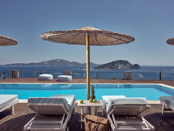 Outdoor pool, an infinity pool, pool umbrellas, pool loungers