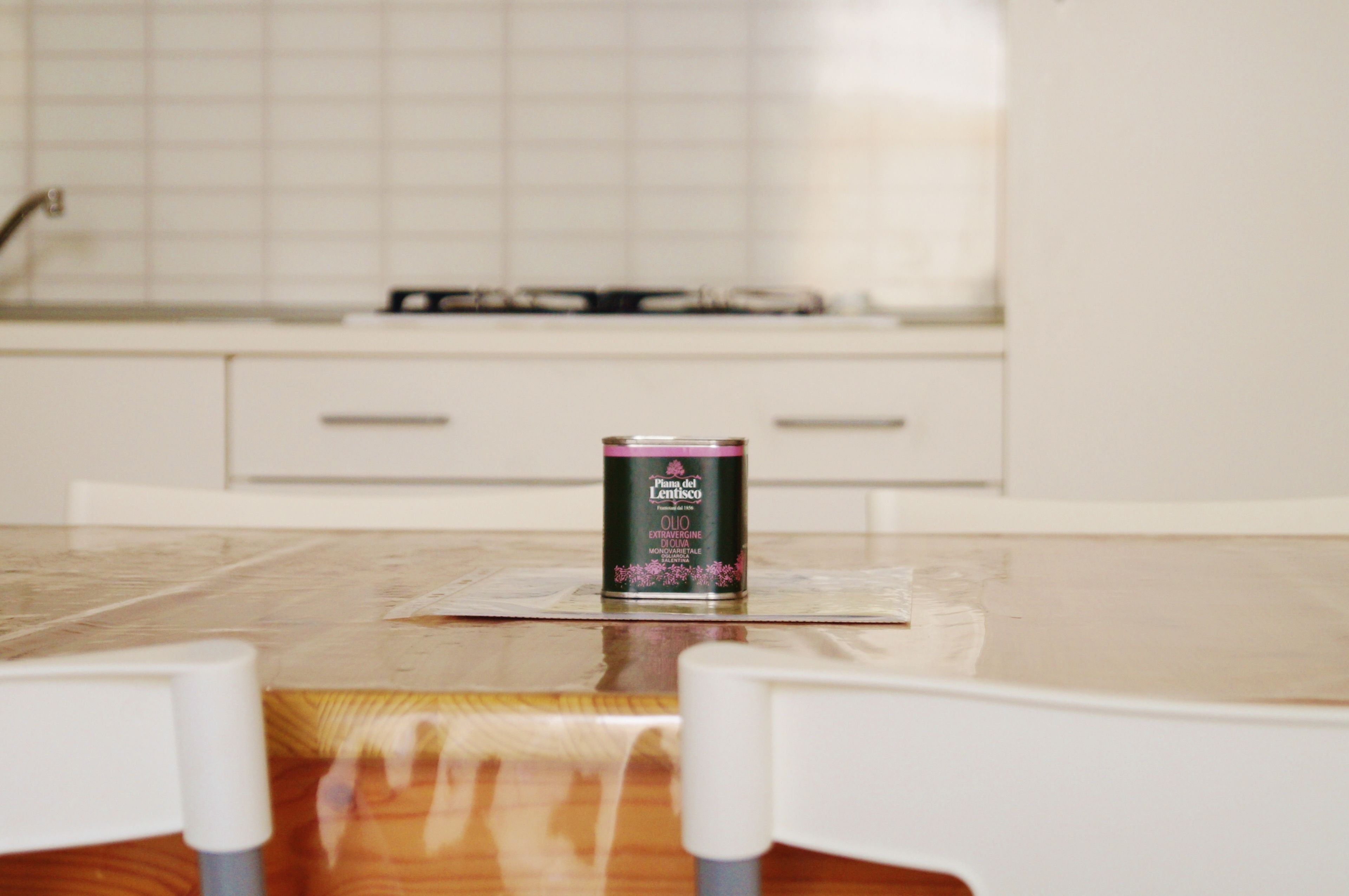 A kitchen with a can of oil on the counter.
