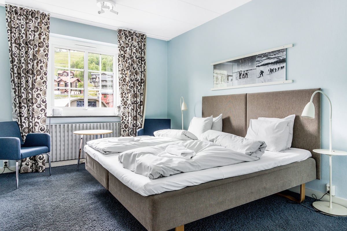 desk, laptop workspace, blackout curtains, bed sheets