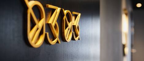 A close-up of a wooden sign with the letters "D" and "O" on a dark background.
