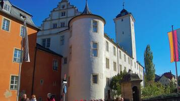 A historic building with a tower and a round corner structure.