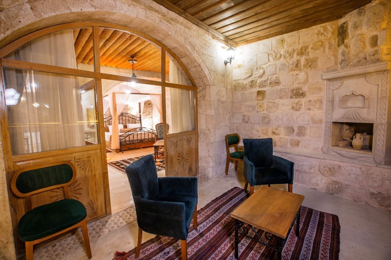 deluxe stone suite | living area | 82-inch lcd tv with satellite channels, tv, heated floors