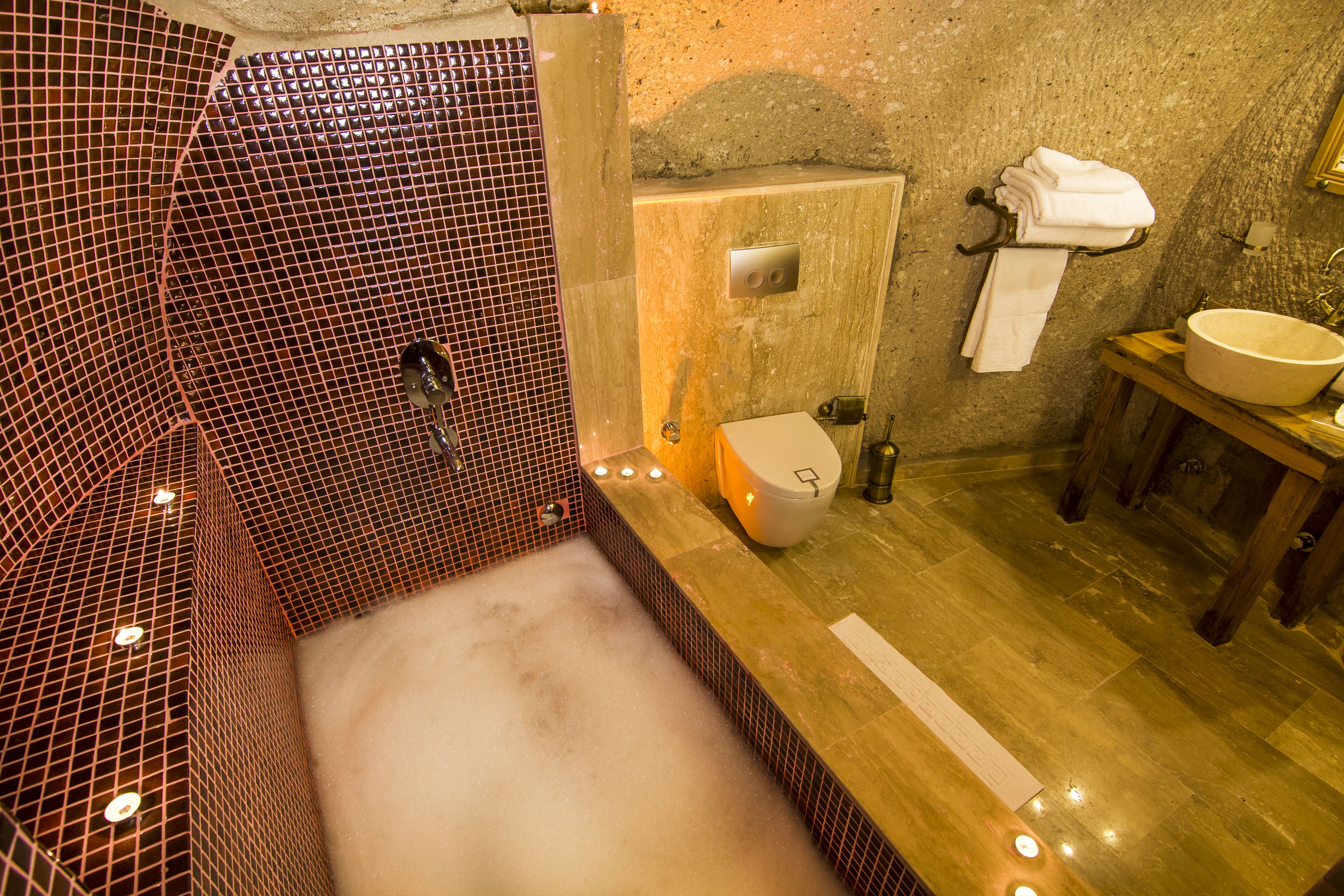 family cave suite | bathroom | designer toiletries, hair dryer, slippers, towels