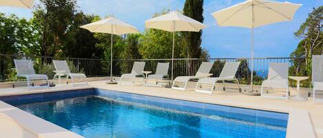 Outdoor pool, open 9:00 AM to 7:00 PM, pool umbrellas, pool loungers