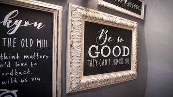 A wall with three framed signs with motivational quotes.
