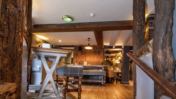 A staircase leading to a dining area with a ping pong table and a bar. - The Old Mill by Chef and Brewer Collection (Coventry)