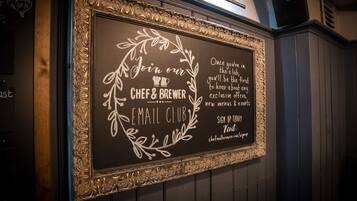 A chalkboard sign with the text "Join our Chef & Brewer Email Club" and a URL for sign-up.