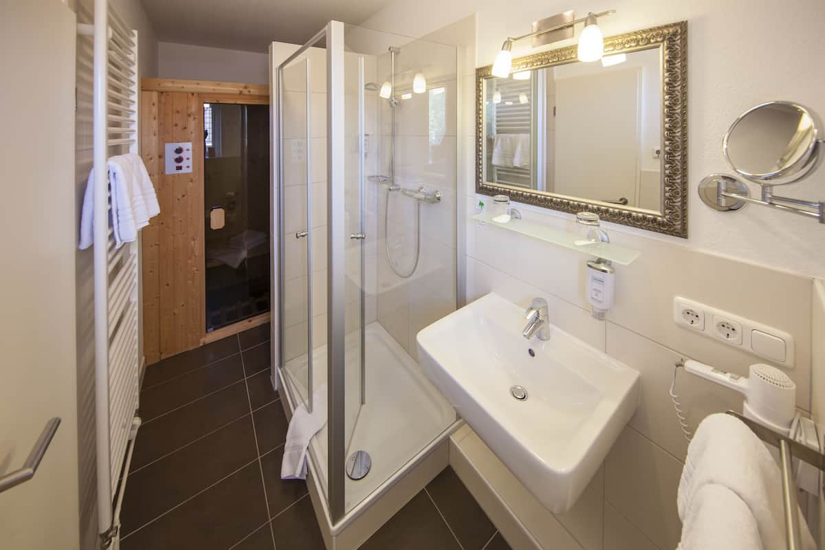 small wellness suite | bathroom | shower, free toiletries, hair dryer, towels