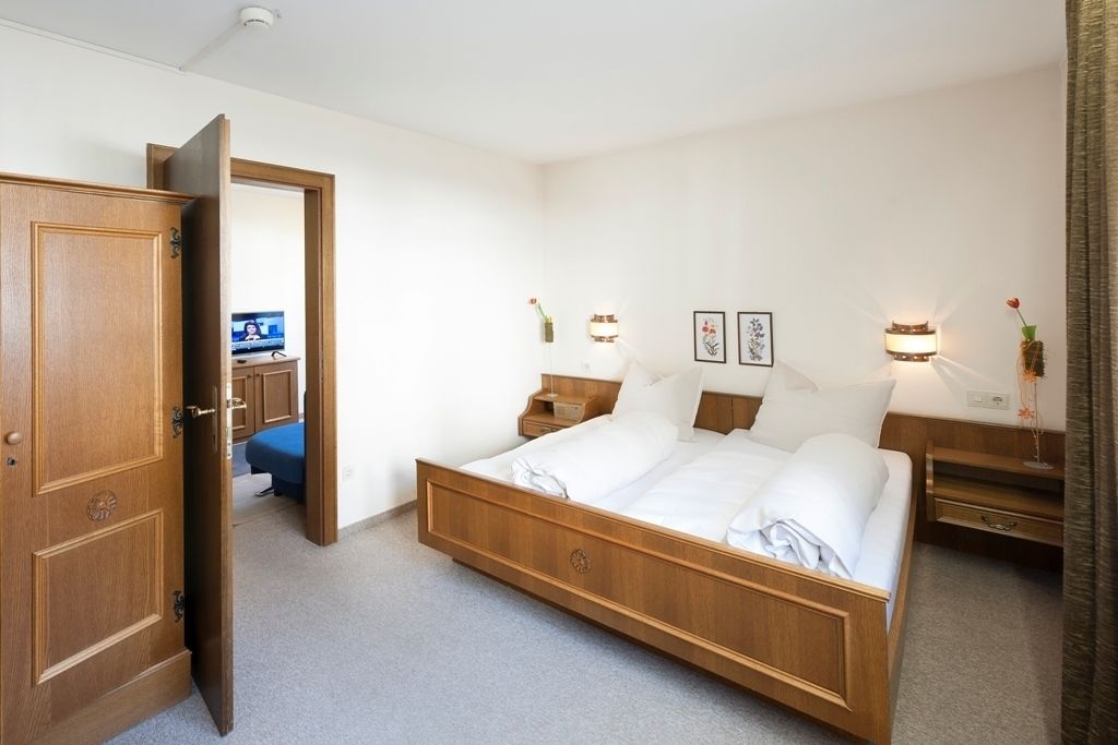 family room, 2 bedrooms, garden view, garden area | in-room safe, bed sheets