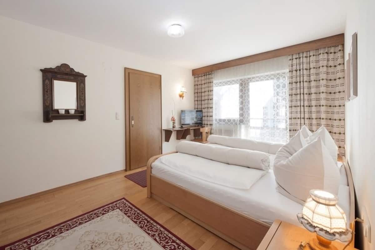 family room, 2 bedrooms, garden view, garden area | in-room safe, bed sheets