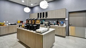 A modern kitchen with a central island, built-in appliances, and a coffee station. - Homewood Suites by Hilton Tyler (Tyler)
