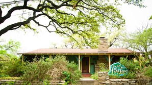 A rustic house with a porch, stone steps, and a sign indicating 'Park Lane'. - Park Lane Guest House (Austin)