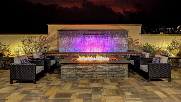 An outdoor seating area with a stone fire feature and a wall-mounted water feature. - Courtyard by Marriott Nashville Mount Juliet (Mount Juliet)