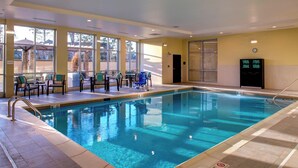 An indoor swimming pool with clear water, surrounded by sunlit seating areas and large windows. - Courtyard by Marriott Nashville Mount Juliet (Mount Juliet)