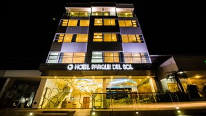 A multi-story hotel with a modern facade, illuminated signage, and a prominent entrance. - Hotel Parque Del Sol (Montería)
