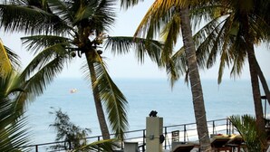 A poolside area with lounge chairs, a hammock, and palm trees. - 36 Palms Boutique Retreat (Kochi)