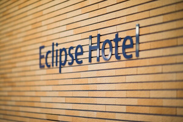 A sign for 'Eclipse Hotel' with a modern design.