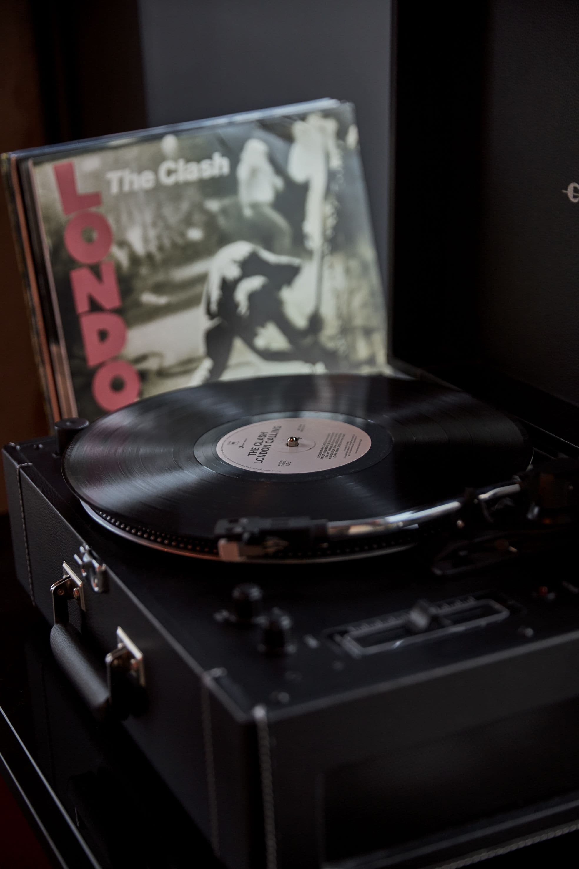 A turntable with a vinyl record and a CD cover titled "The Clash - London".