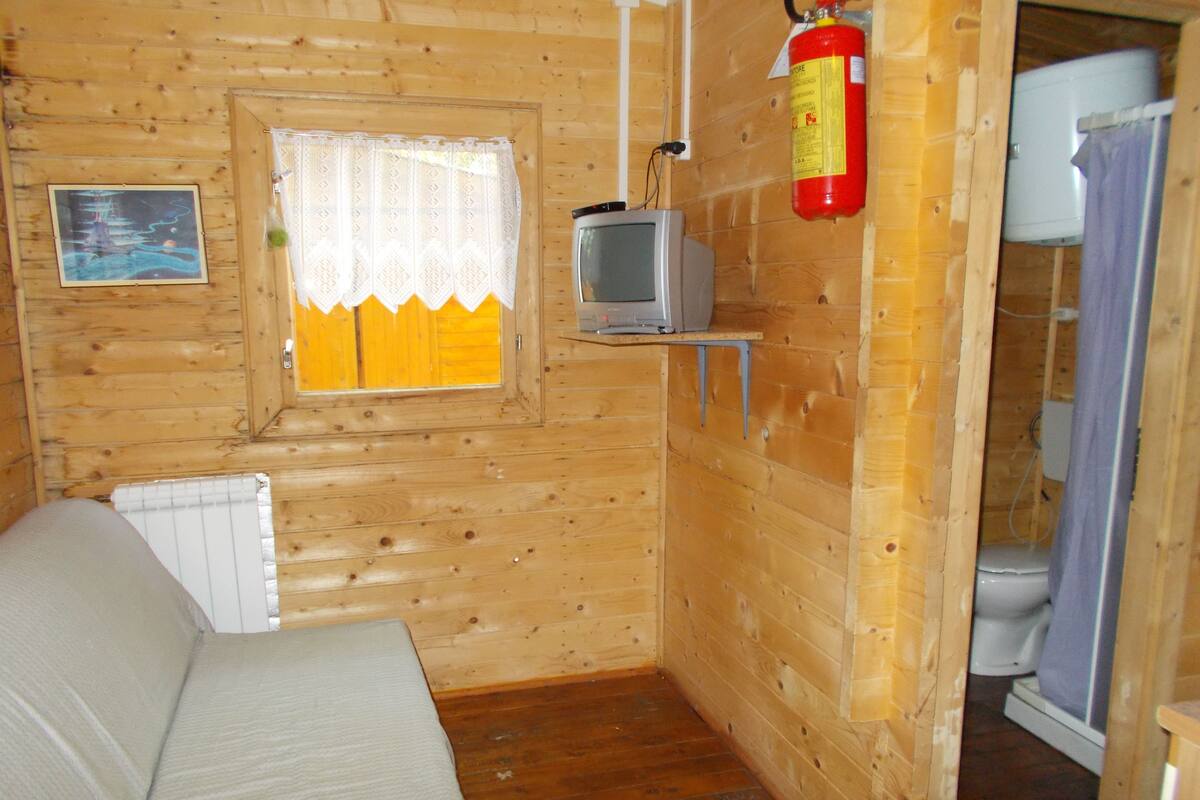 Triple Room, Private Bathroom | Living area | TV