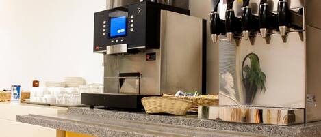 A coffee machine with a digital display, a milk frother, and a coffee dispenser.