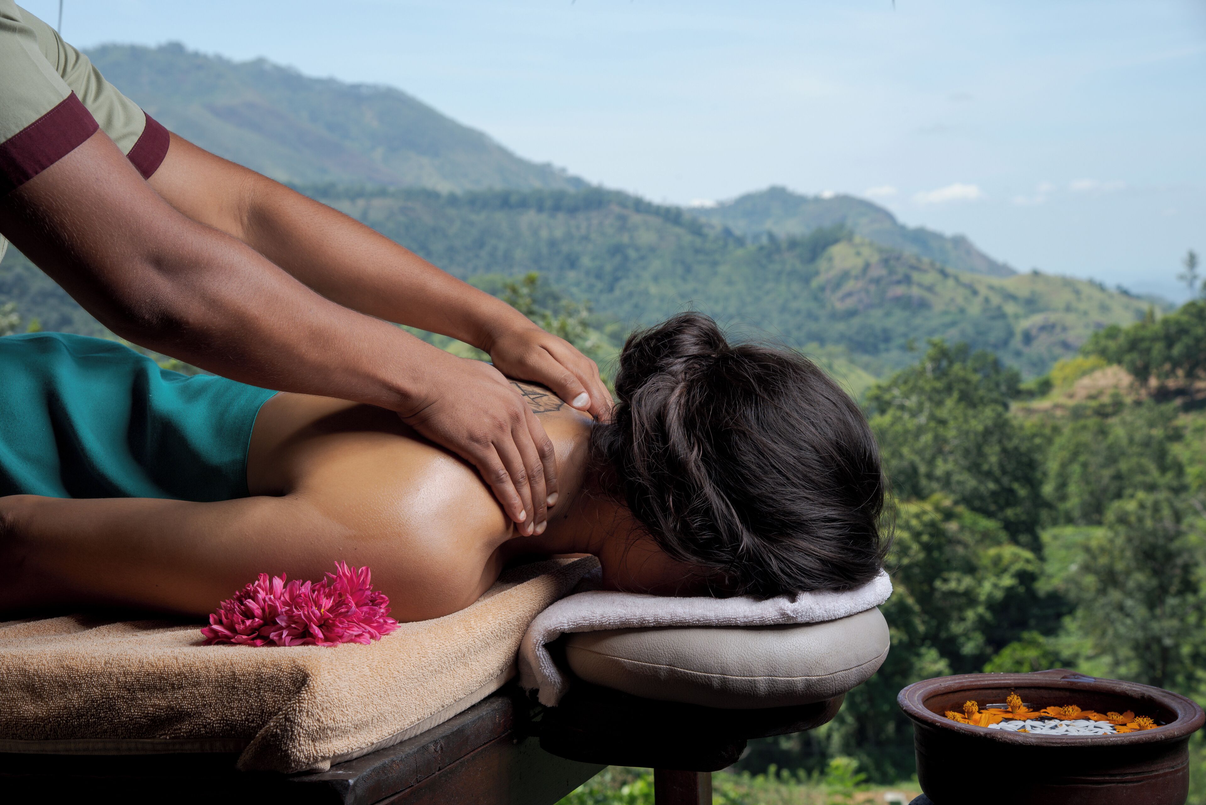 A massage therapy session with a scenic mountain backdrop.
