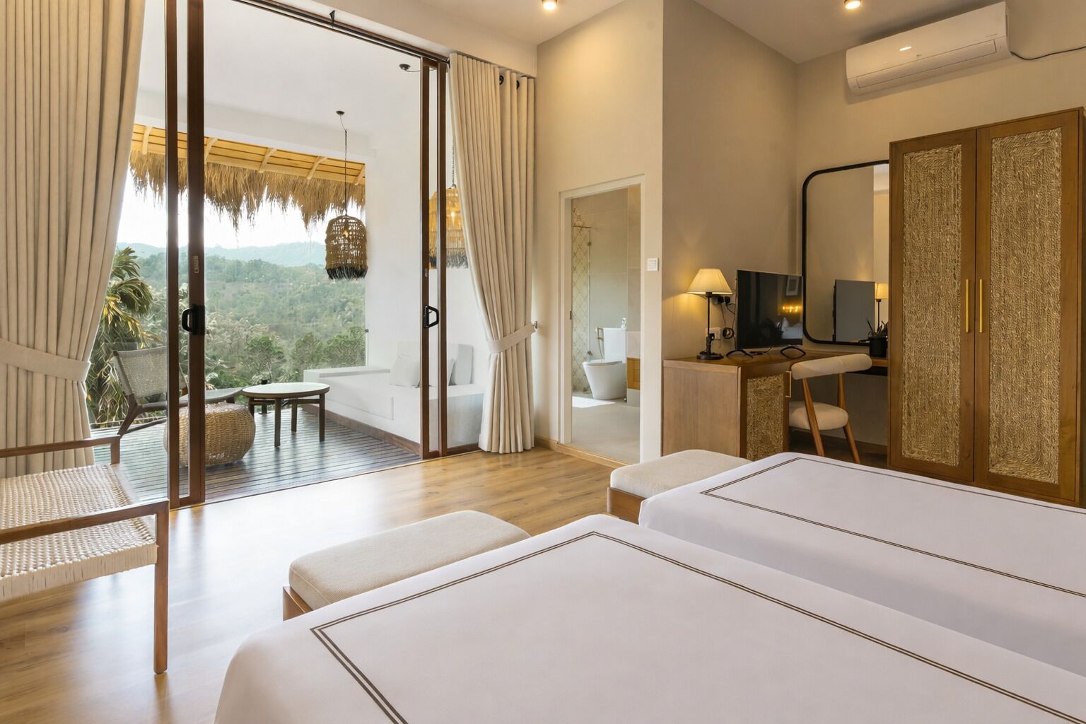 Een hotelkamer met balkon, bureau, spiegel en bed.