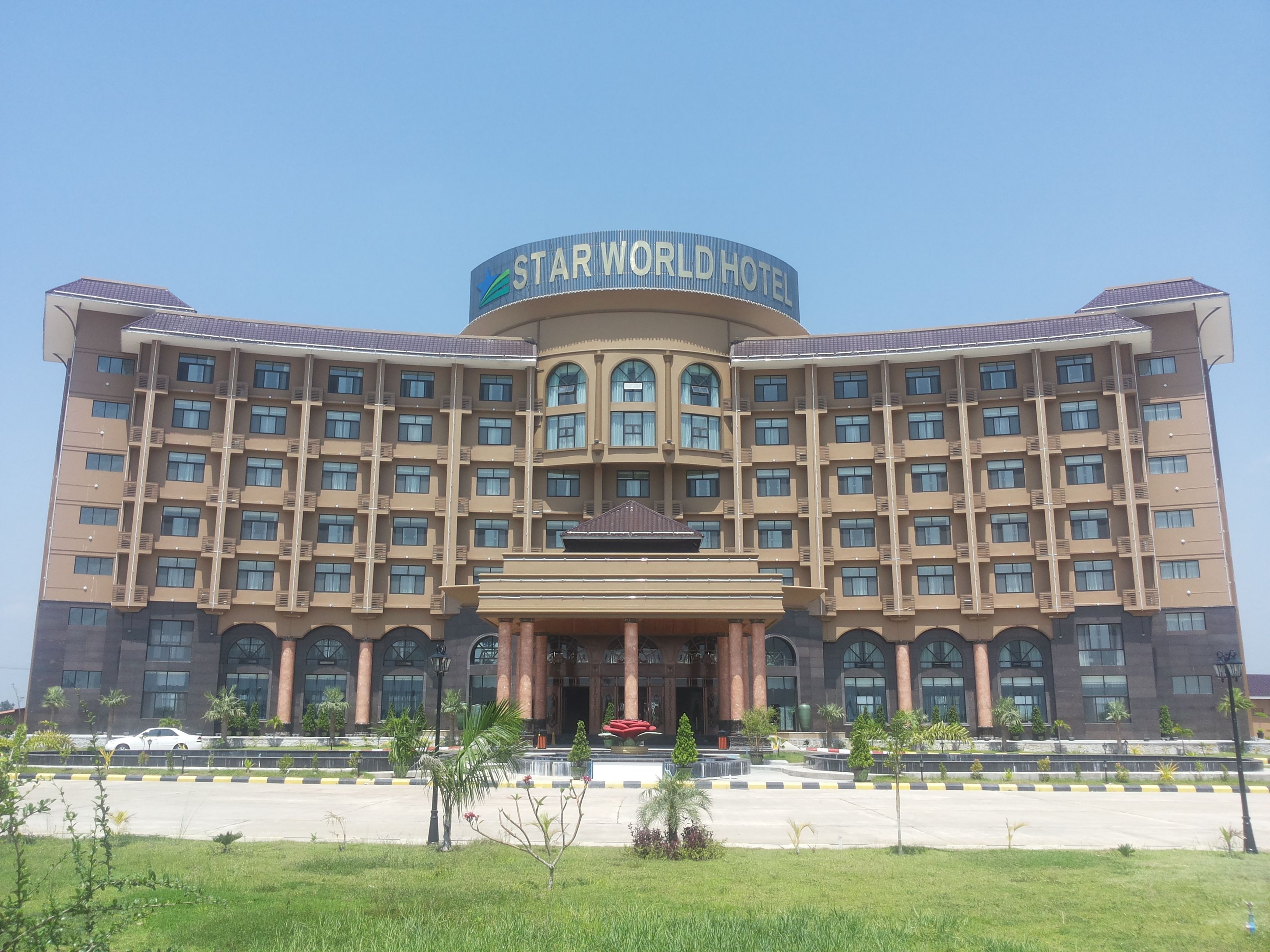 A large hotel with a prominent sign reading "STAR WORLD HOTEL". It features a symmetrical facade with multiple windows and balconies.