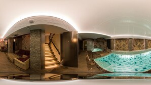 A spa with a central staircase, a pool area, and a seating area with a view of the pool. - Argo Trakai (Trakai)