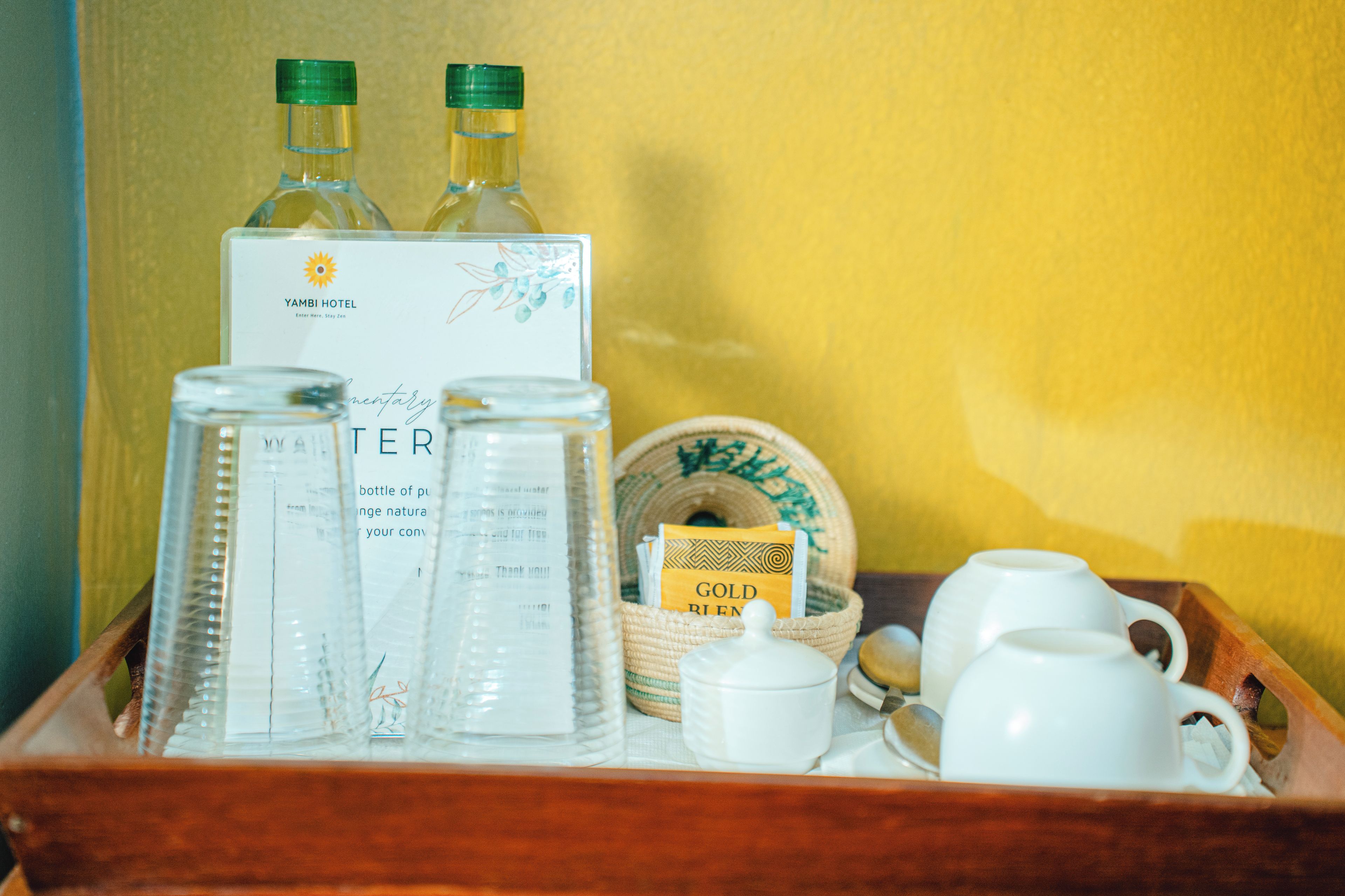 A tray with bottles, a sign, a jar, and a dish with a label.