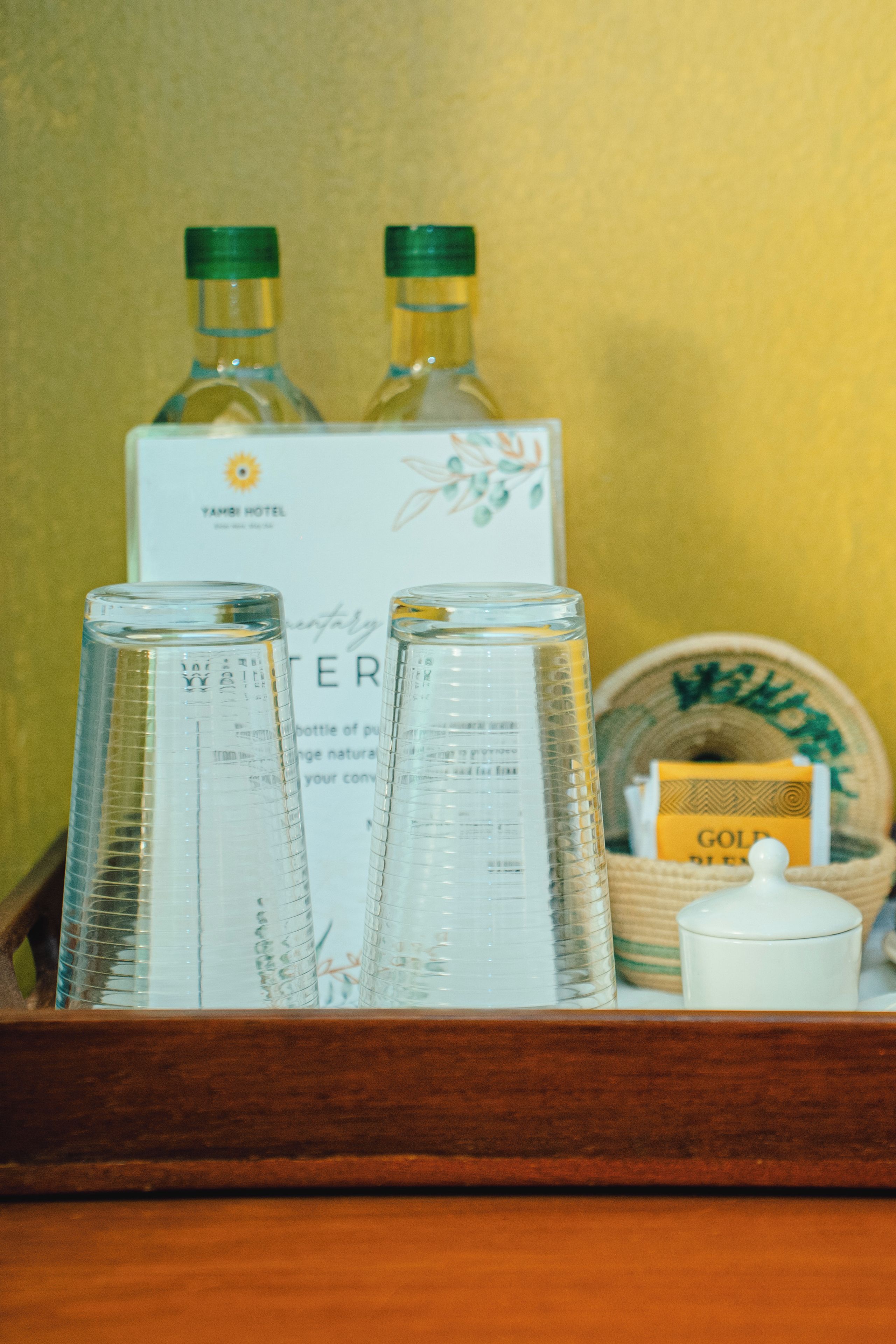 A tray with two bottles, a box, and a container.