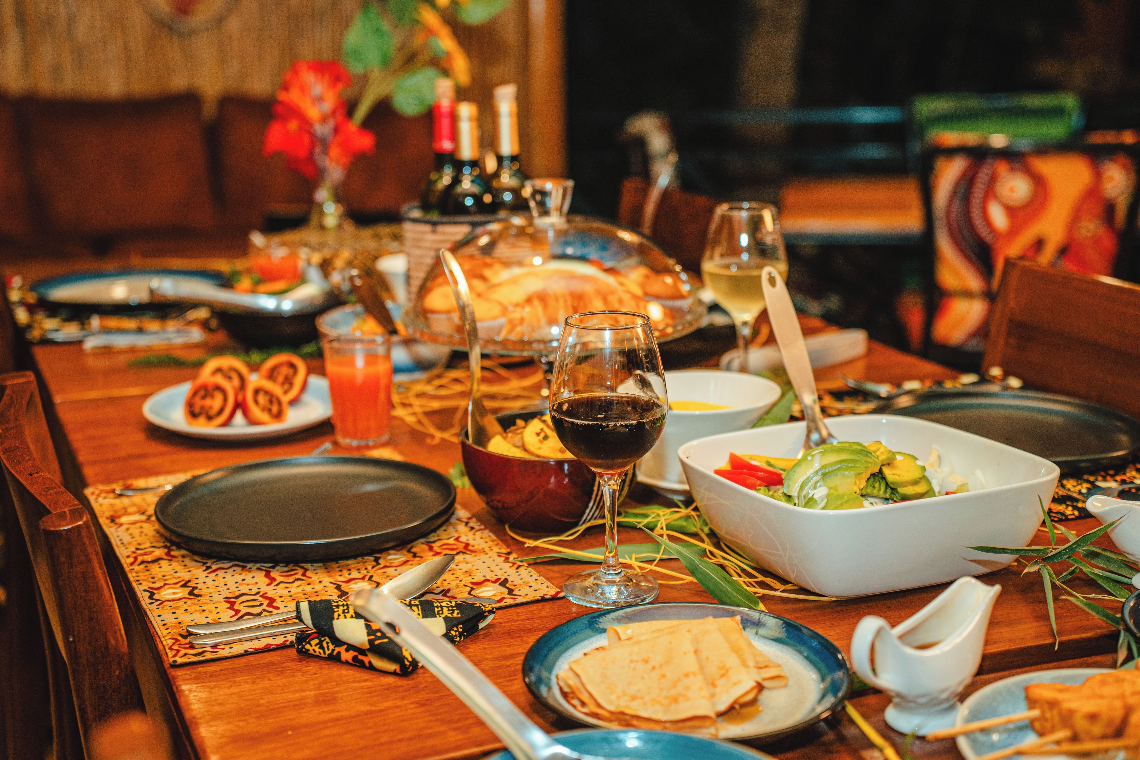 A dining table set with plates, glasses, and cutlery, indicating a meal setting.
