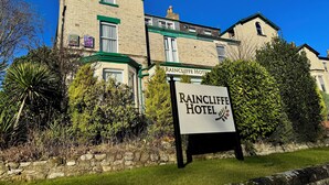 A traditional brick building with a green roof and a sign for Raincliffe Hotel. - Raincliffe Hotel (Scarborough)