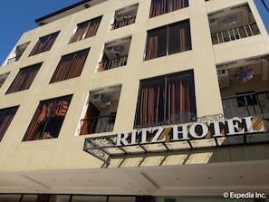 A multi-story building with a sign reading "Ritz Hotel". - Ritz Hotel (Angeles City)
