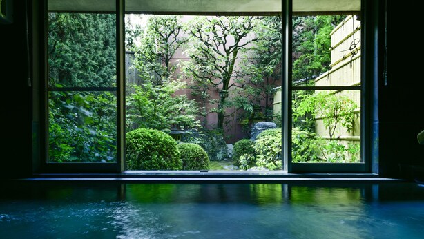 A view through a large window with a water feature in the foreground. - Yamadaya Ryokan (Kyoto)