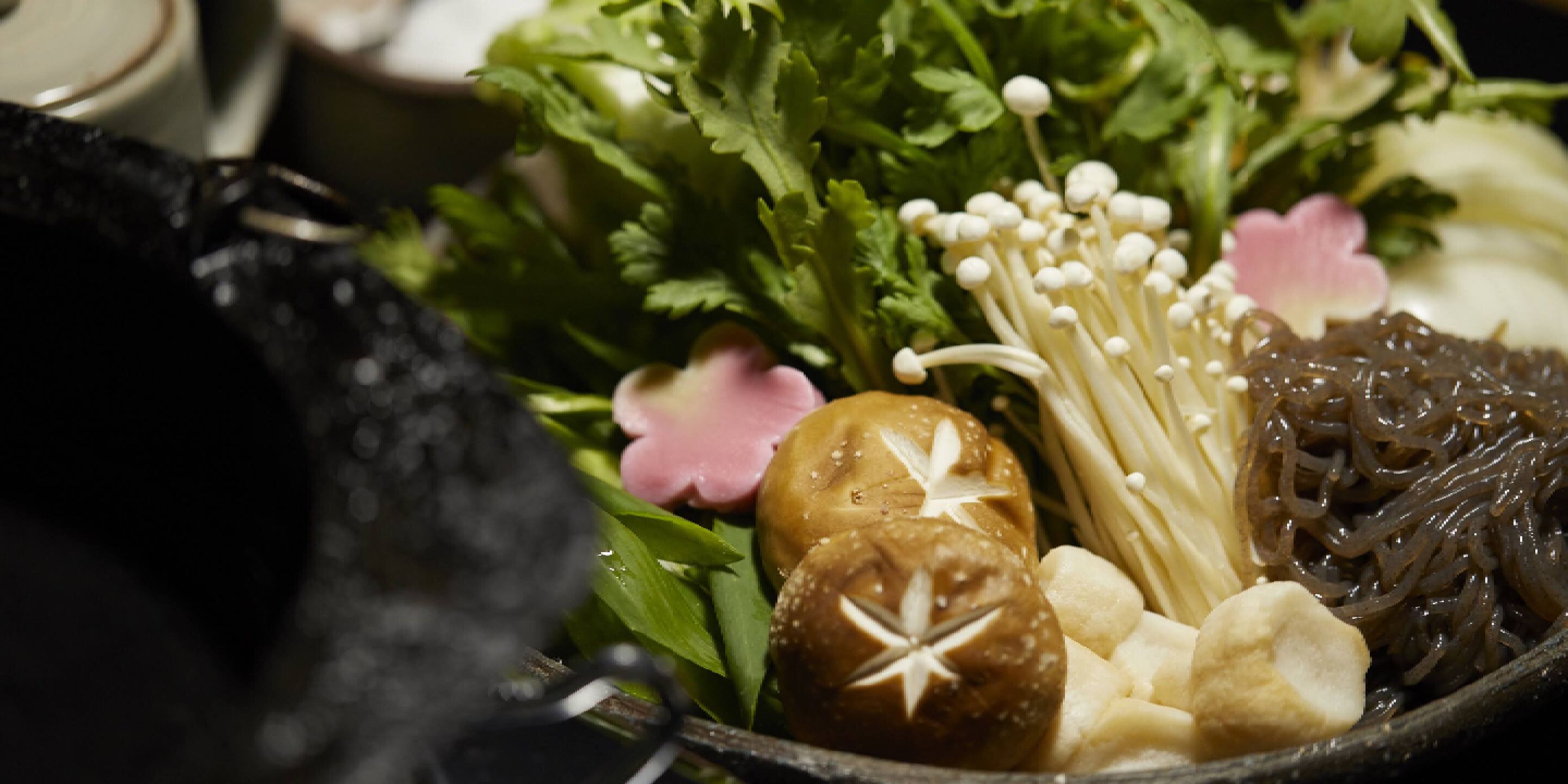 A bowl of assorted food items including mushrooms, seaweed, and other vegetables.